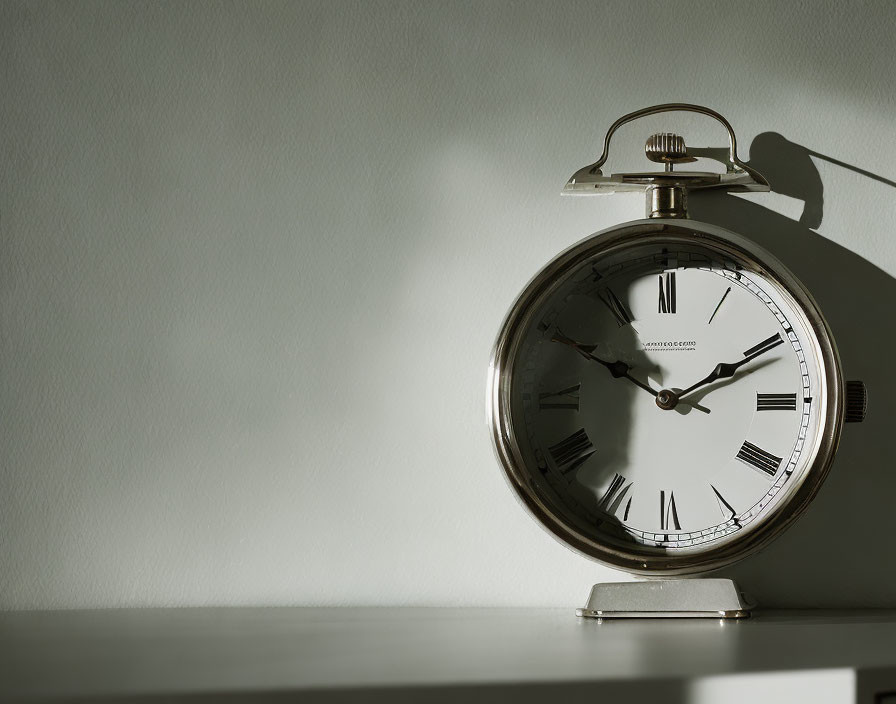 Vintage pocket watch casting shadow in sunlight