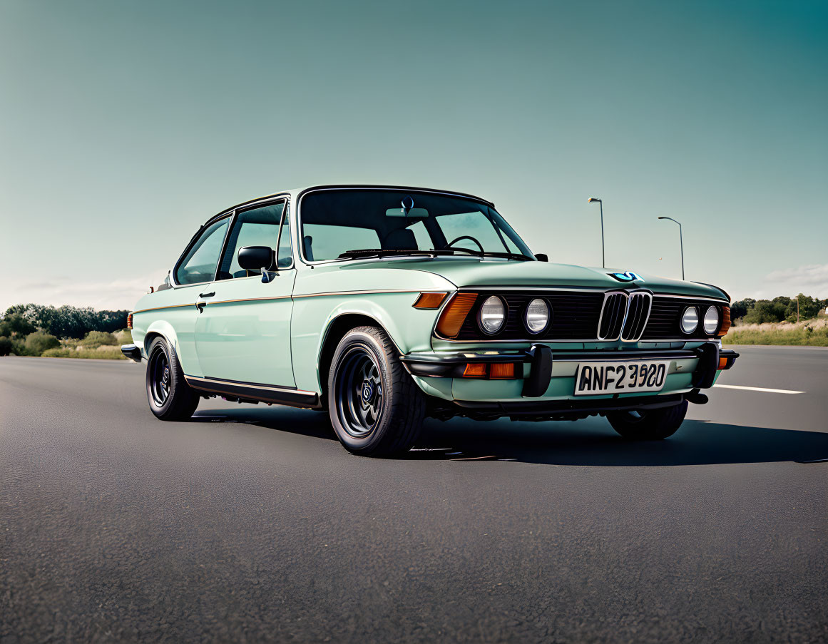 Vintage BMW Car with Mint Turquoise Paint on Asphalt Road