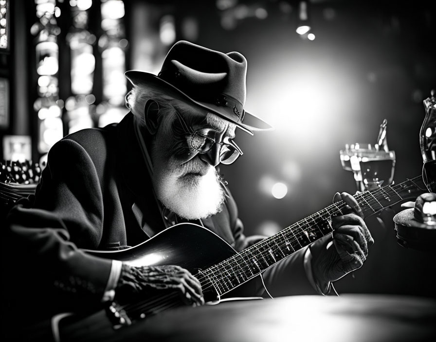 Elderly man with beard playing guitar in dimly lit bar