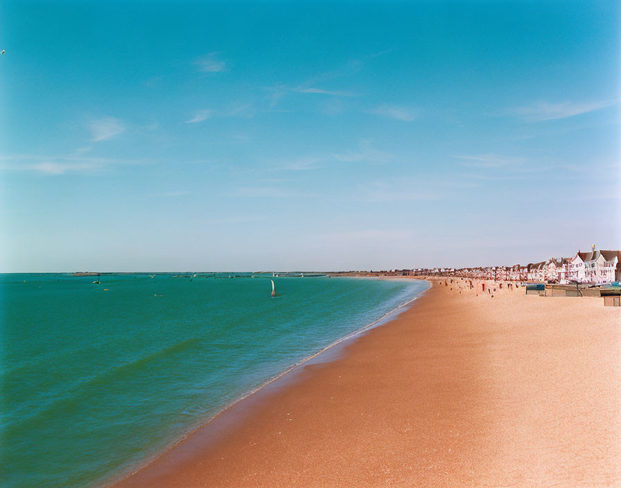 Tranquil beach scene with clear skies and calm sea