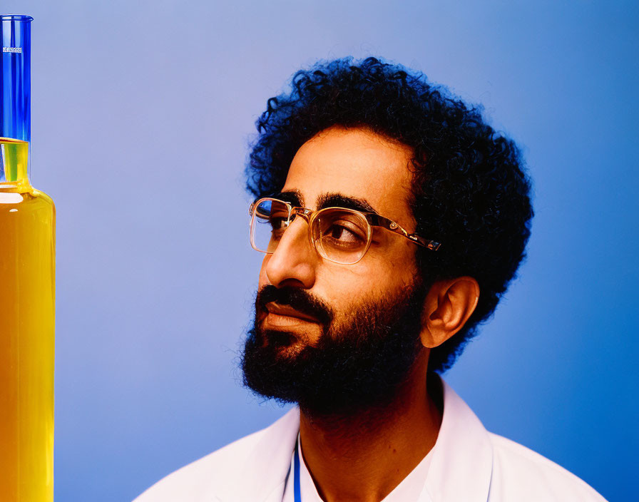 Curly-Haired Man in Lab Coat with Glasses and Yellow Flask on Blue Background