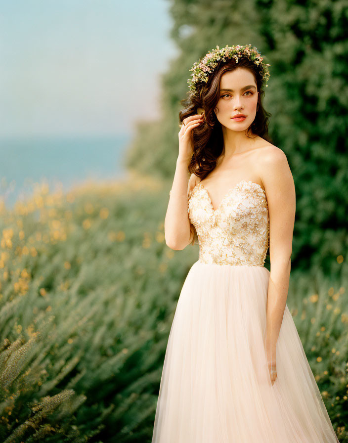 Bride in strapless gown with floral headpiece among yellow flowers