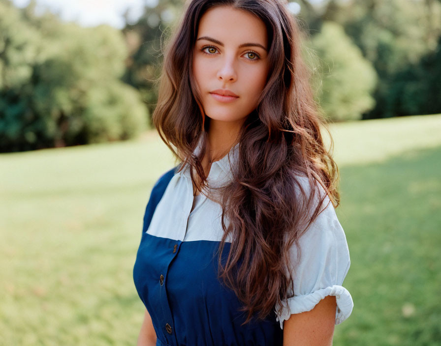 Woman with Long Brown Hair in White Blouse and Blue Dress in Sunny Park