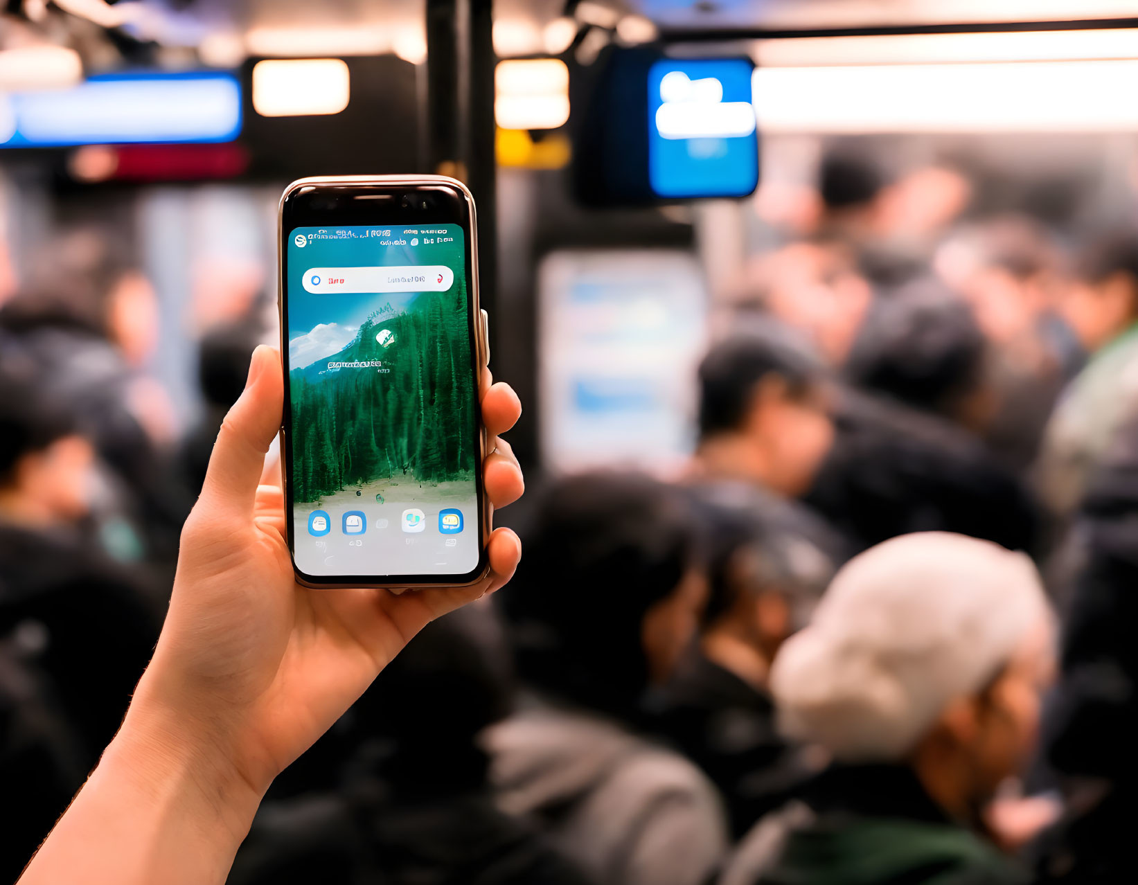 Person holding smartphone with green wallpaper in crowded subway train