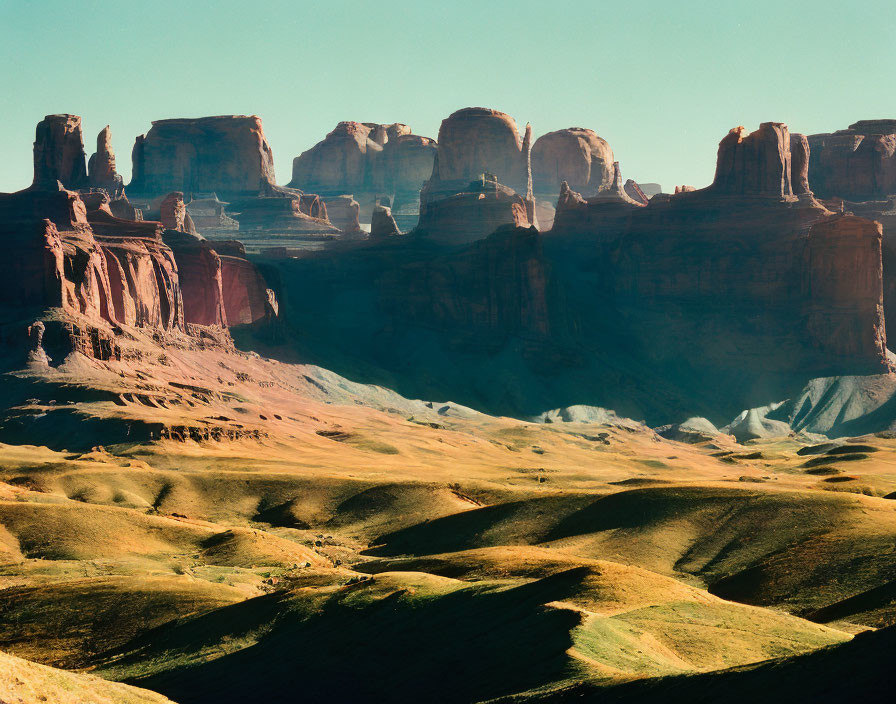 Desert landscape with red rock formations under blue sky