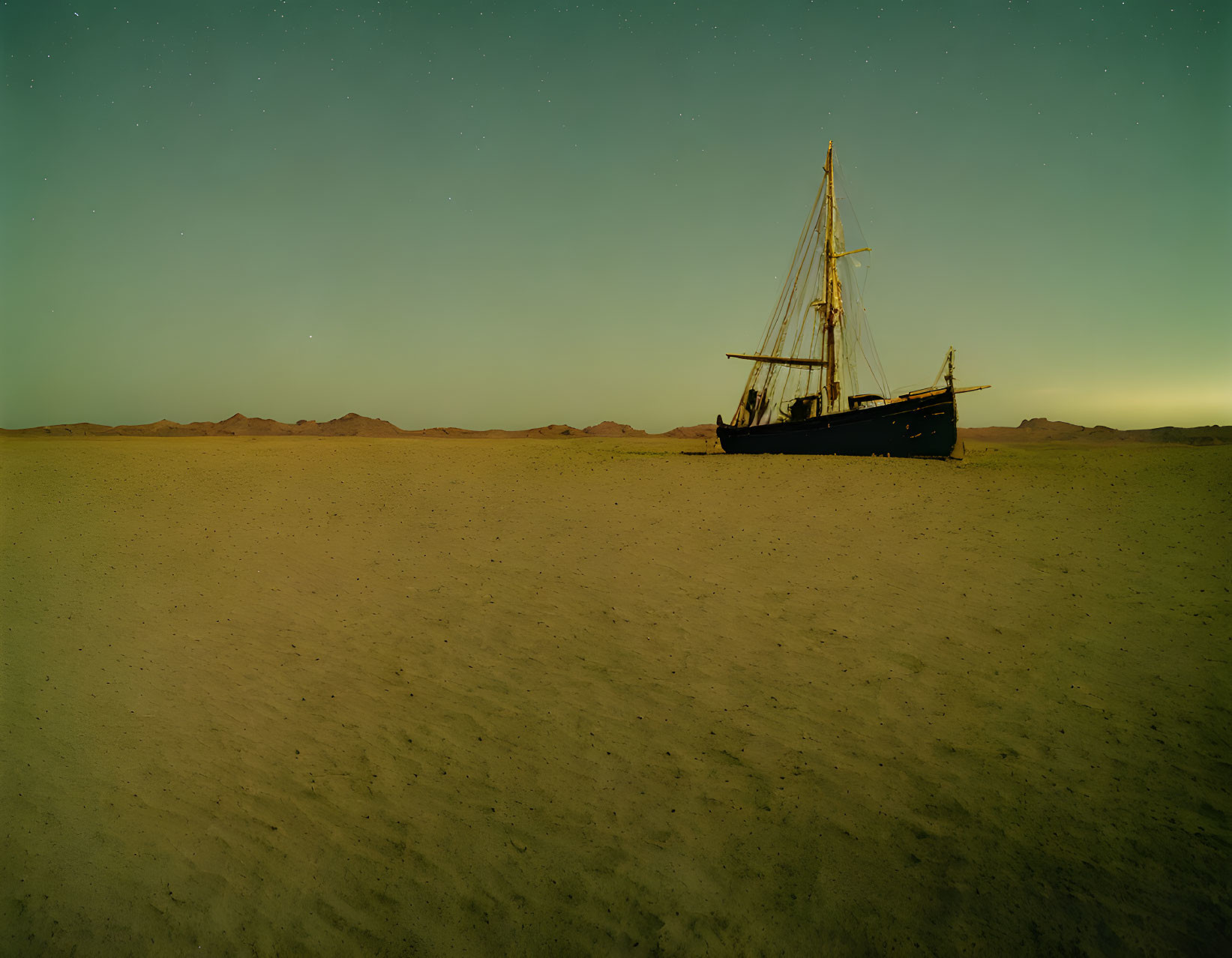 Abandoned ship in desert landscape under twilight sky