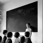 Confident young boy speaks to peers in classroom setting