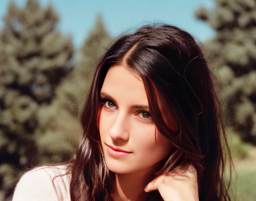 Smiling woman with long dark hair in nature portrait