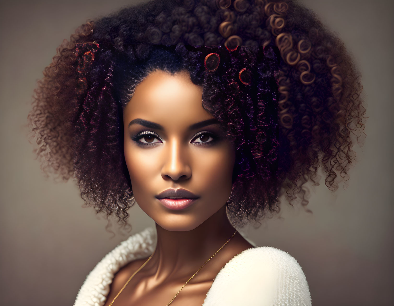 Woman with Curly Hair and Flowers in Elegant White Garment