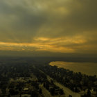 Dusk landscape with dark clouds and sunset glow on hills