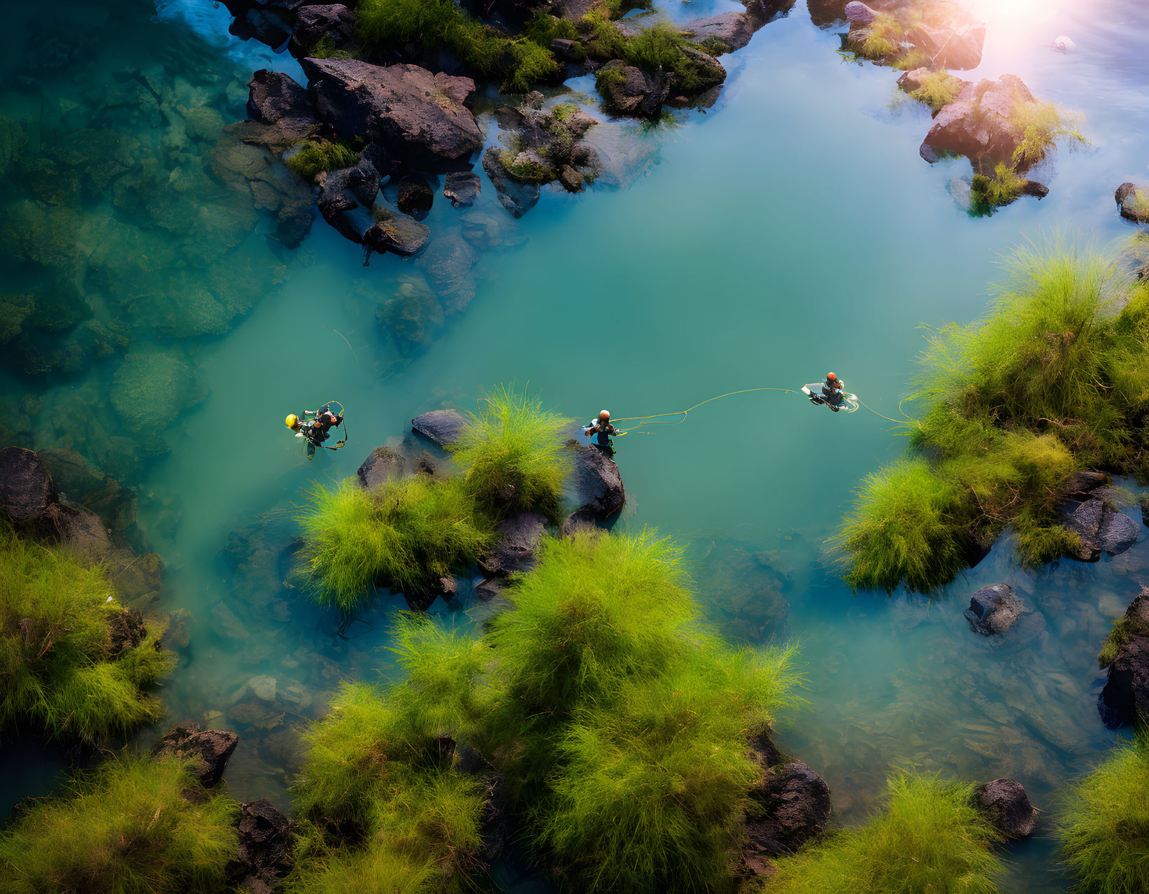 Tranquil river fishing scene with three people in clear water