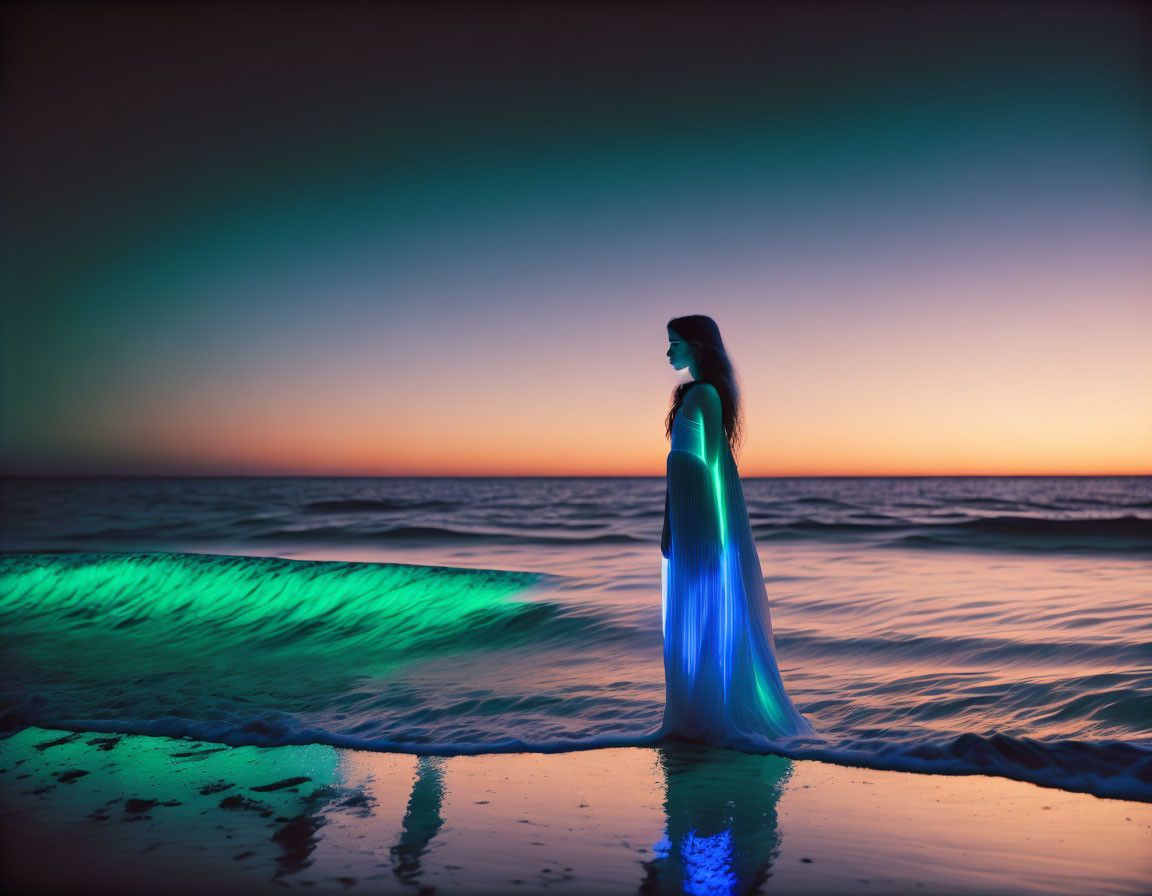 Silhouette of woman at twilight on beach with colorful dress reflecting on water.