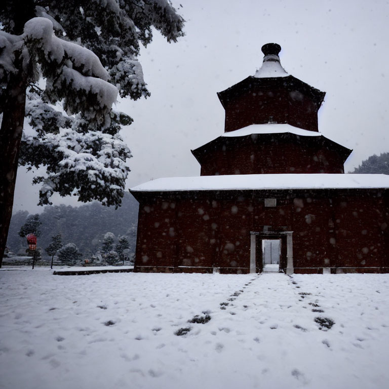 Traditional multi-tiered building with conical roof in snowy landscape.