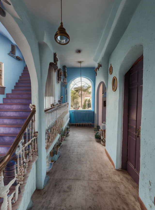 Elegant Victorian-style hallway with curving staircase, decorative railings, light blue walls, pendant light