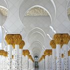 Intricate Islamic mosque interior with arched doorways & geometric patterns