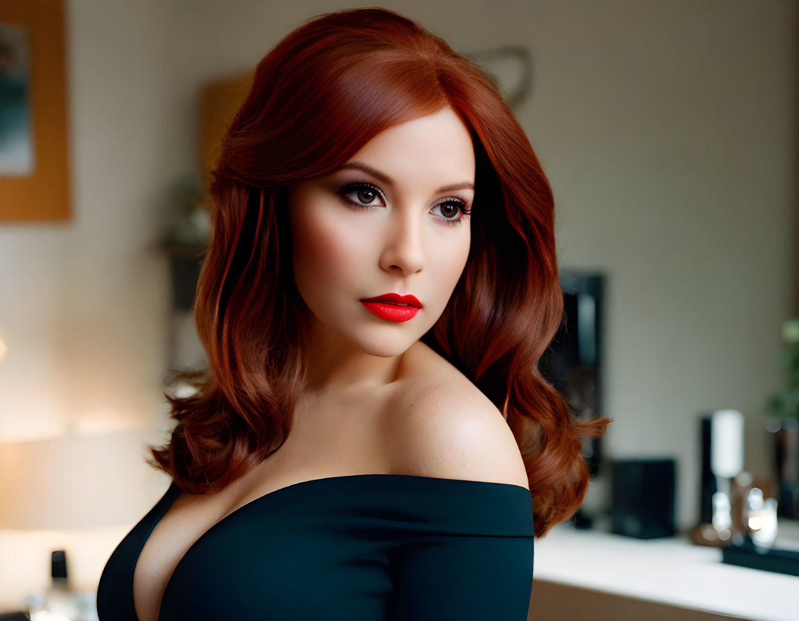 Red-haired woman in black off-shoulder top with red lipstick gazes sideways.