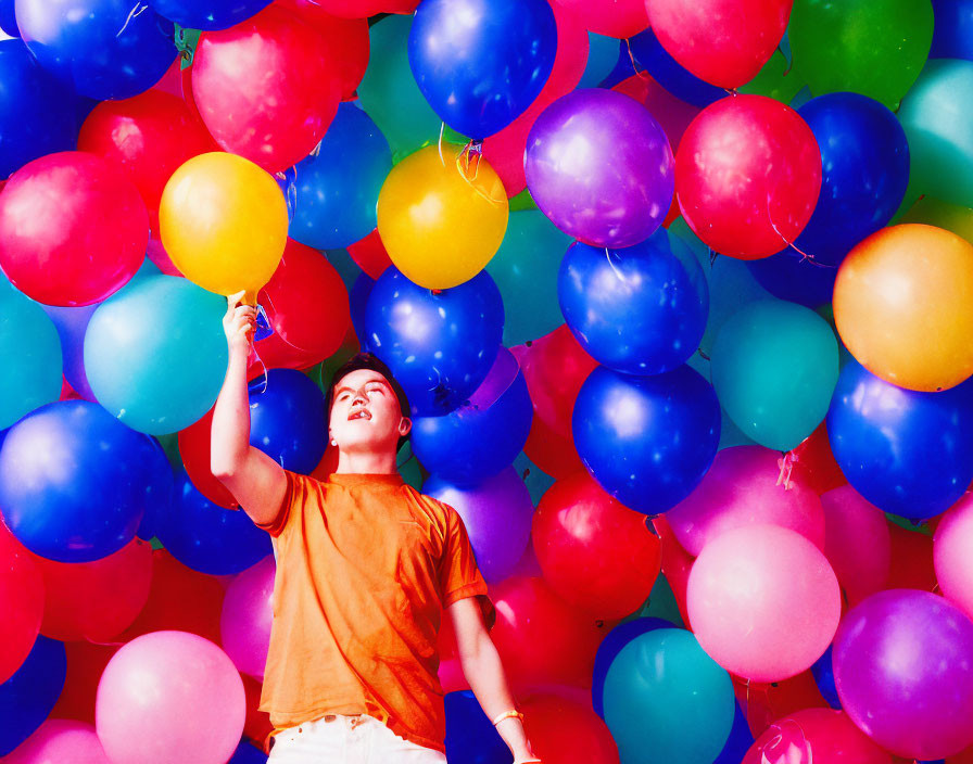 Colorful Balloon Background with Joyful Person Holding Yellow Balloon