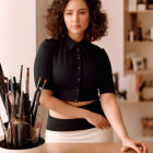 Confident professional woman with medium-length hair at desk in dark blouse.