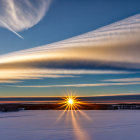 Vibrant sunset over snowy landscape with streaked clouds