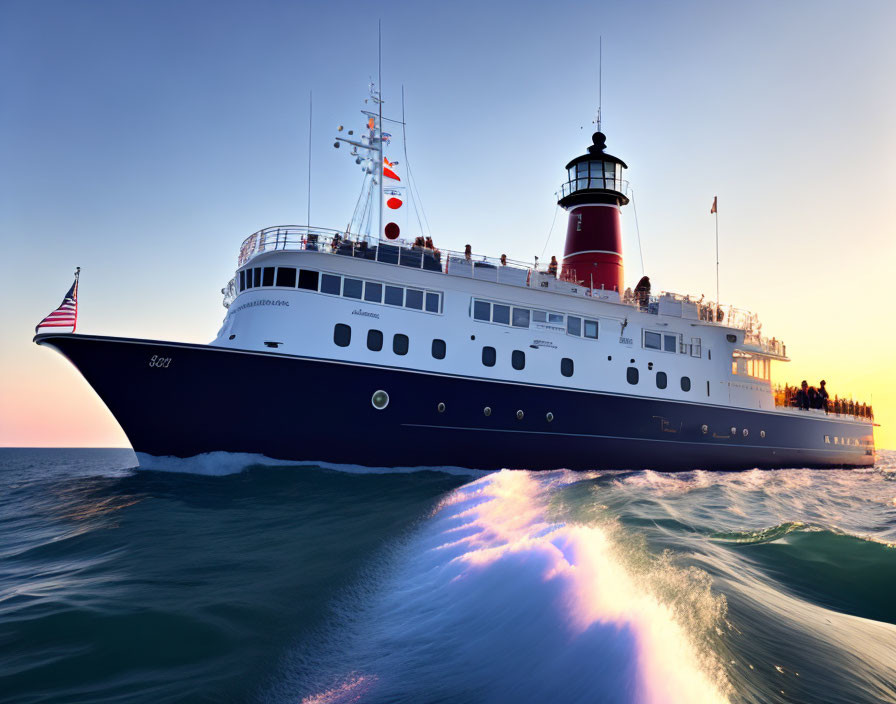 Vintage yacht sailing at sunset with illuminated lighthouse and blue wake