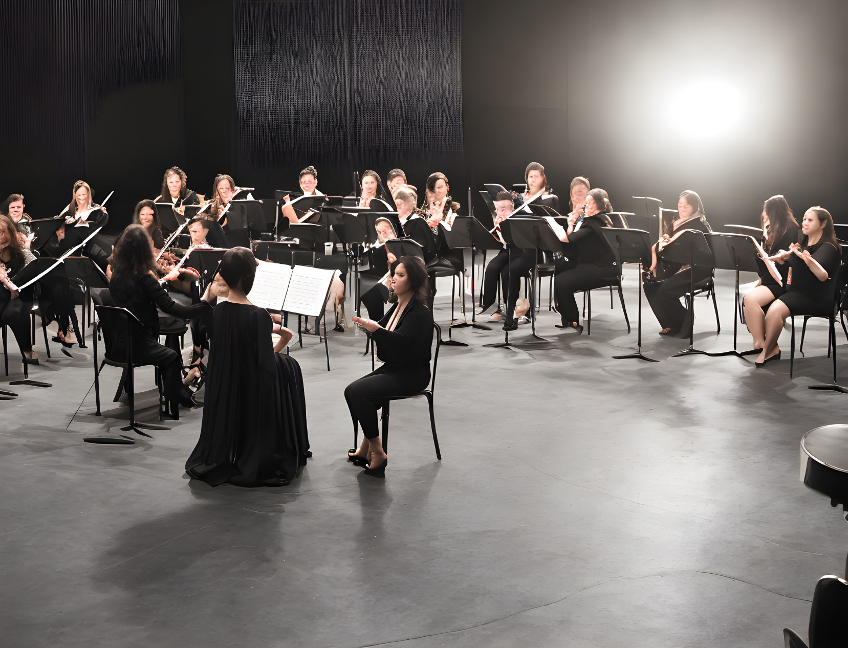 Orchestra musicians in formal attire playing string instruments