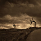 Tranquil evening landscape with glowing cottage, windmill, misty river, warm twilight sky