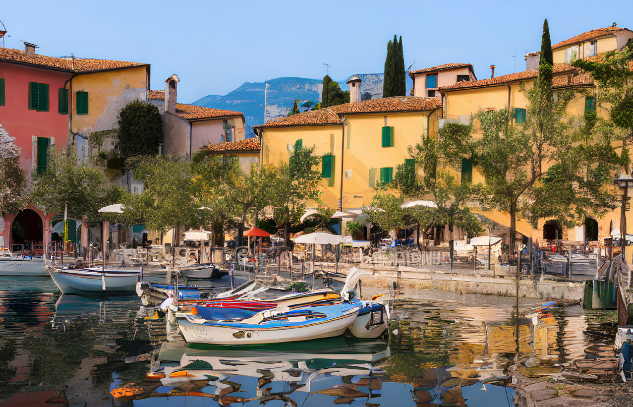 Vibrant lakeside buildings, boats, and mountains at dusk