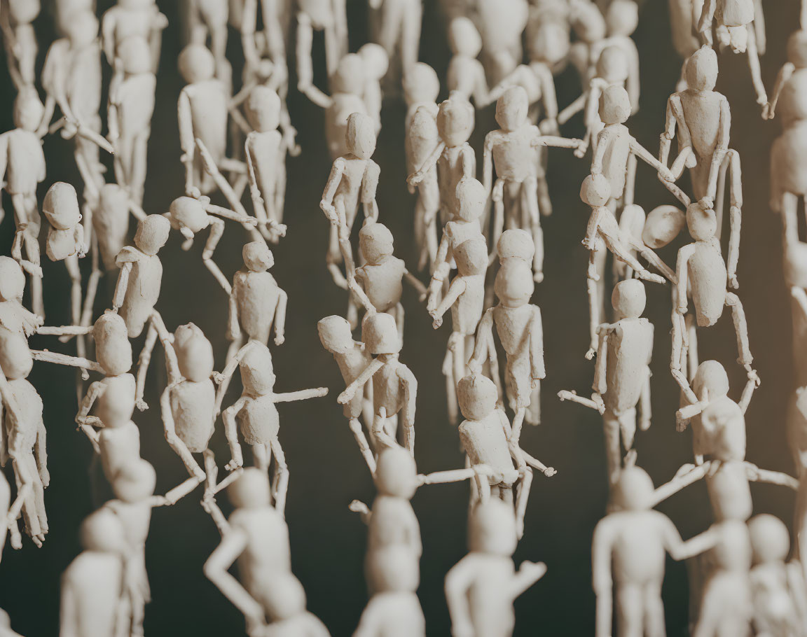 Wooden artist mannequins suspended in shadowy space