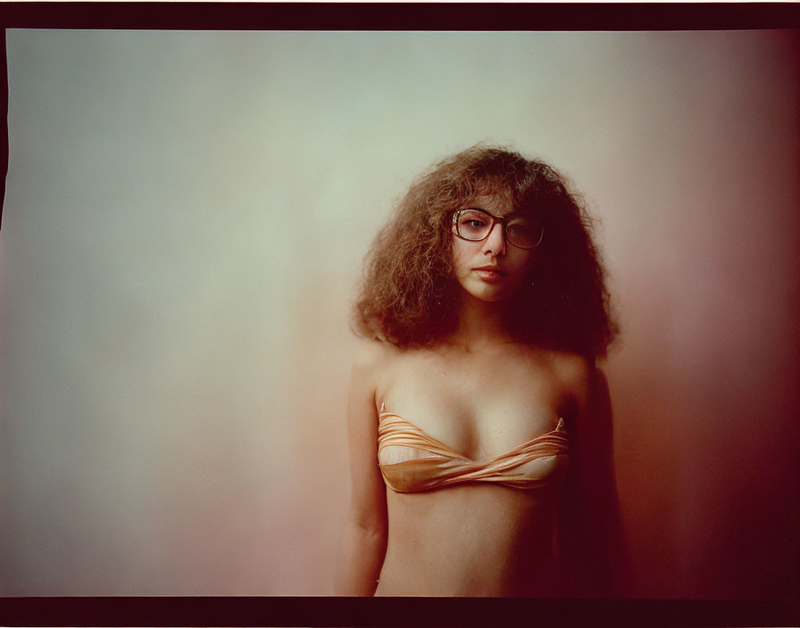 Curly-Haired Woman in Glasses with Creative Top Knot Portrait