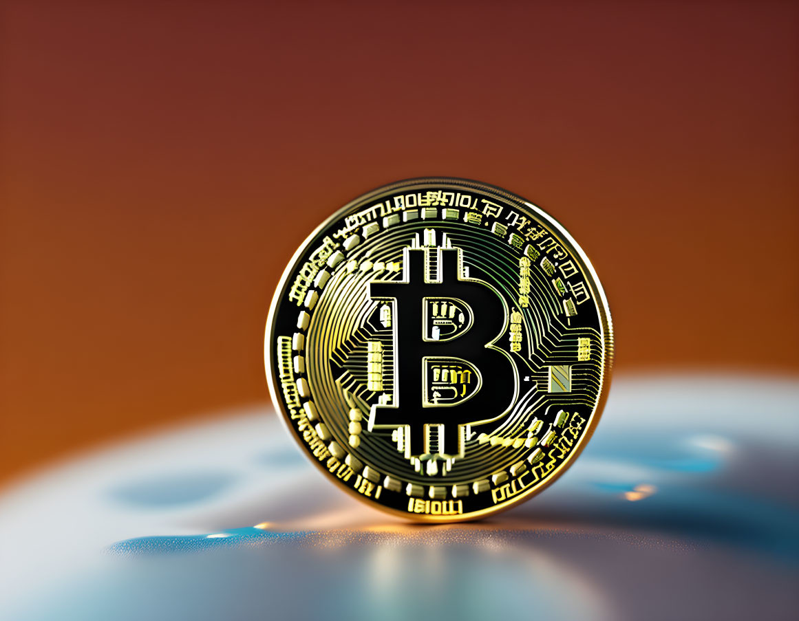 Gold Bitcoin Token on Blurred Orange Background