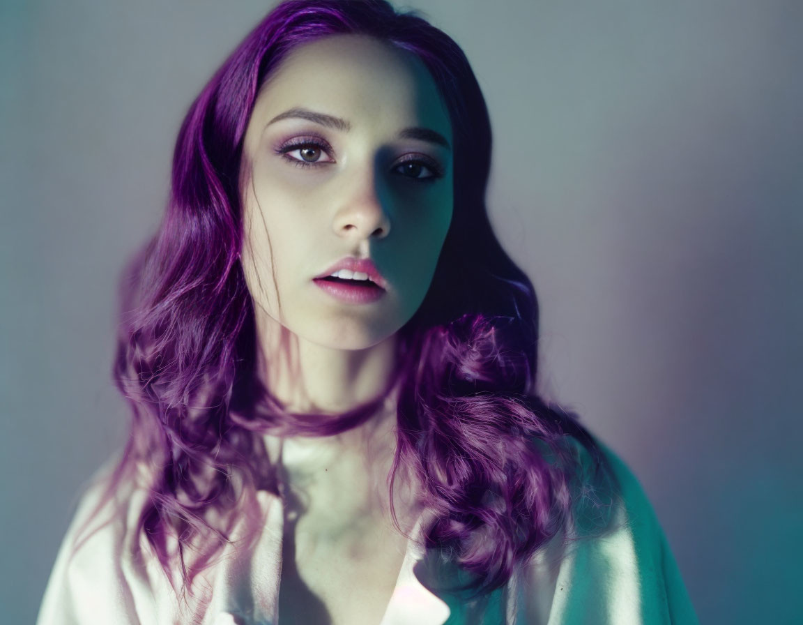 Portrait of Woman with Purple Hair and Piercing Eyes in Moody Lighting