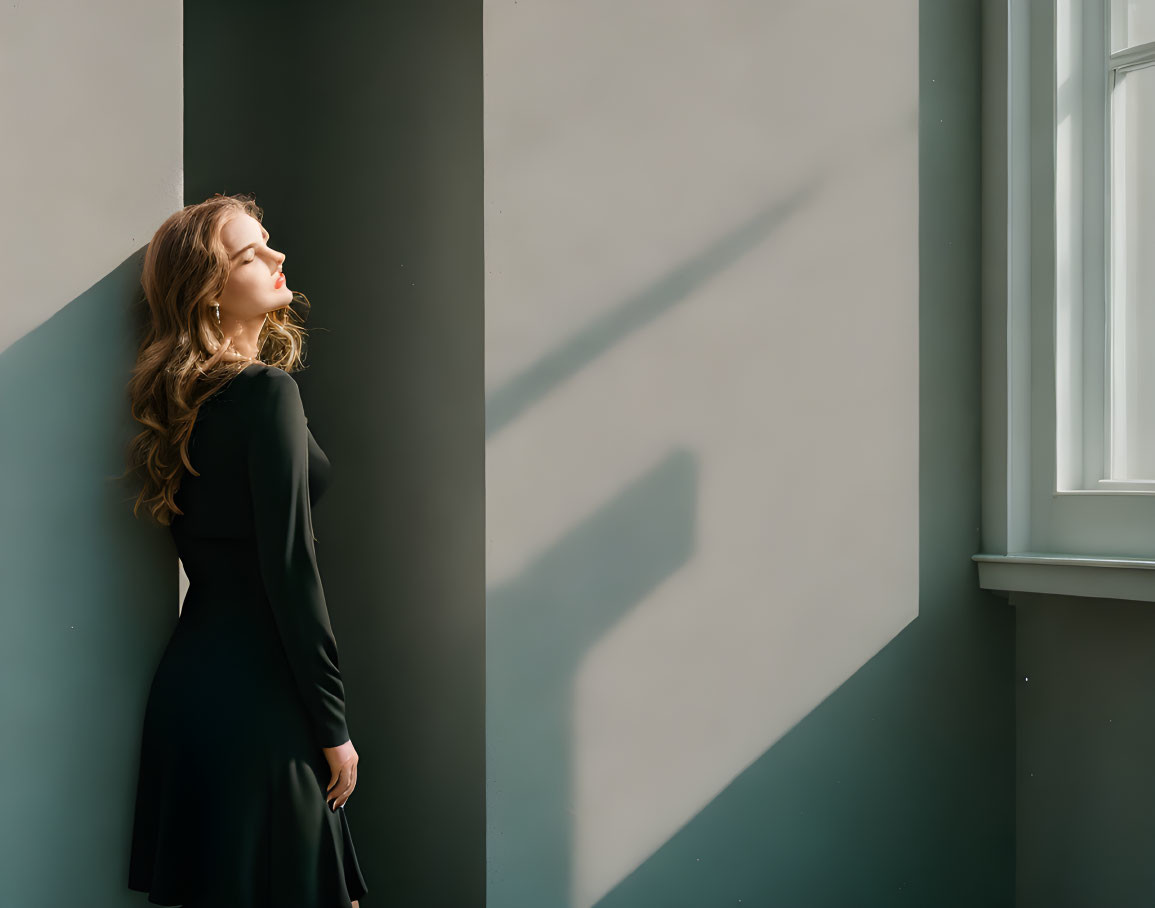 Woman in Black Dress Basks in Sunlight by Window, Casting Shadow