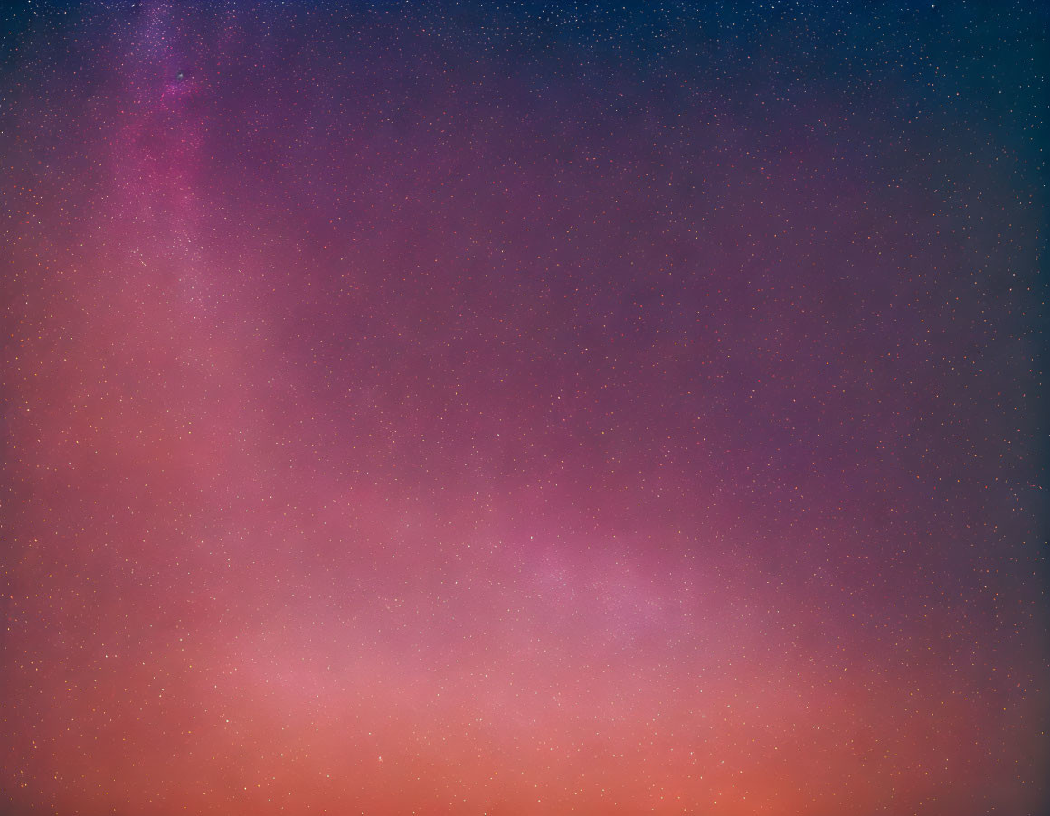 Twilight hues transition from deep blues to warm reds with scattered stars in sky