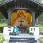 Regal Figure in Blue and Gold Attire on Throne under Ornate Archway