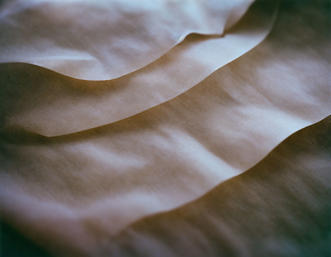 Silky fabric with gentle shadows and highlights forming textured landscape