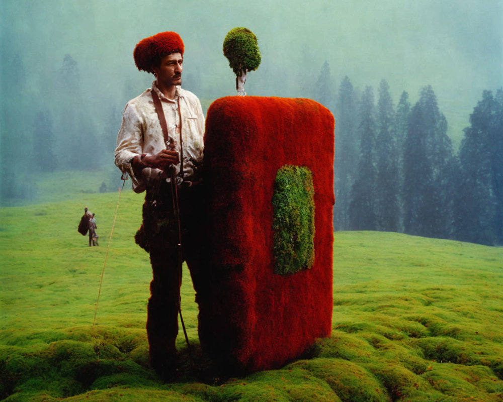 Traditional Attire Man with Moss-Covered Book-Like Object in Green Field