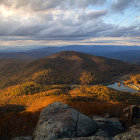 Vibrant autumn landscape with rolling hills and distant villages