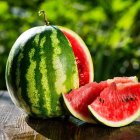 Ripe Watermelon and Sliced Piece with Red Flesh and Black Seeds