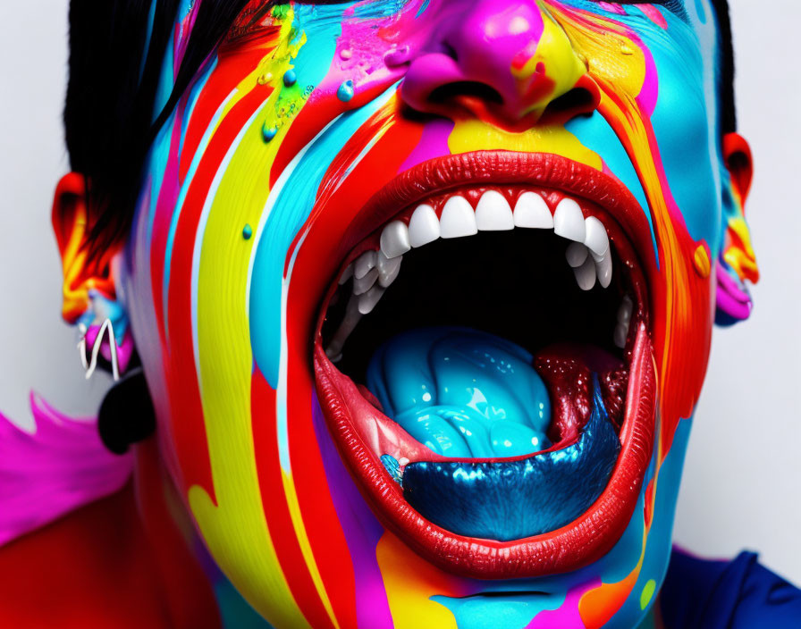 Vibrant multicolored paint streaming down person's face close-up