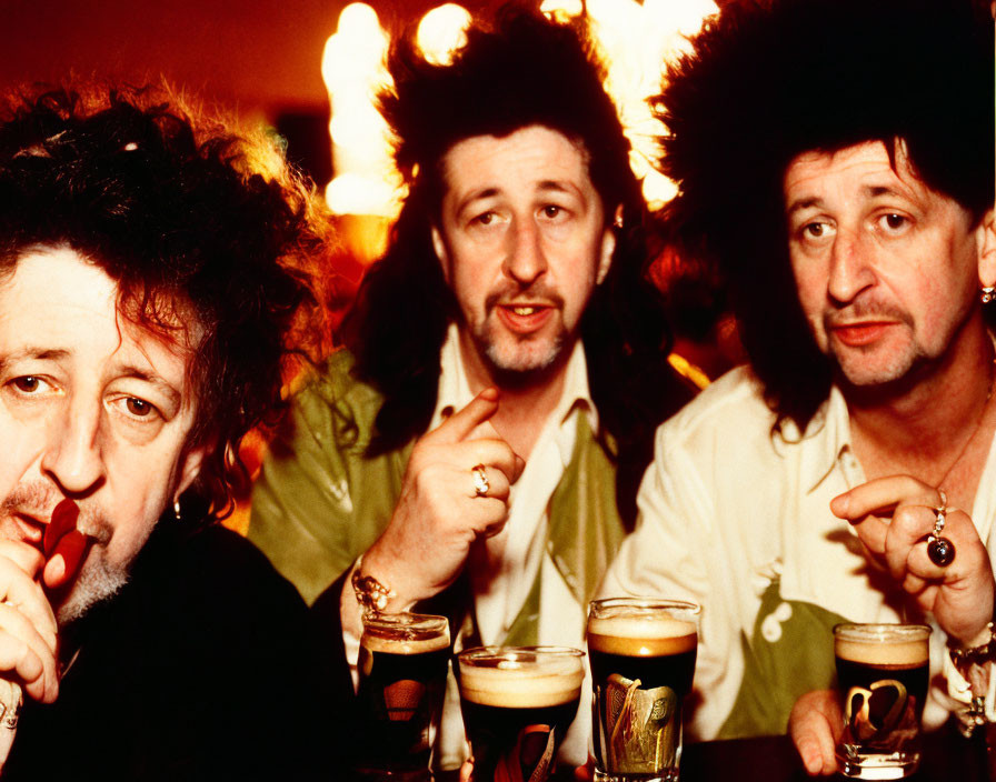 Men with unique hairstyles chatting at a bar with drinks