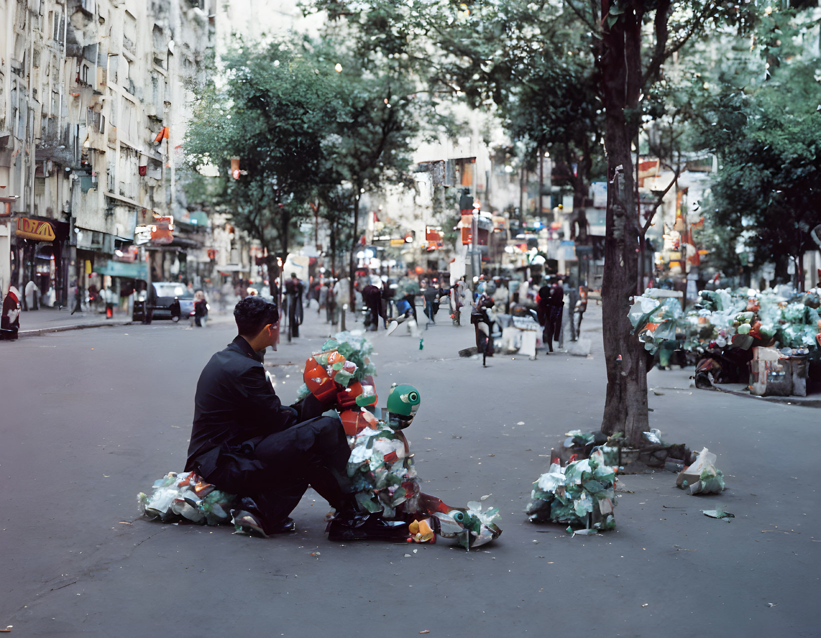 Man sitting on curb surrounded by trash bags in urban street scene