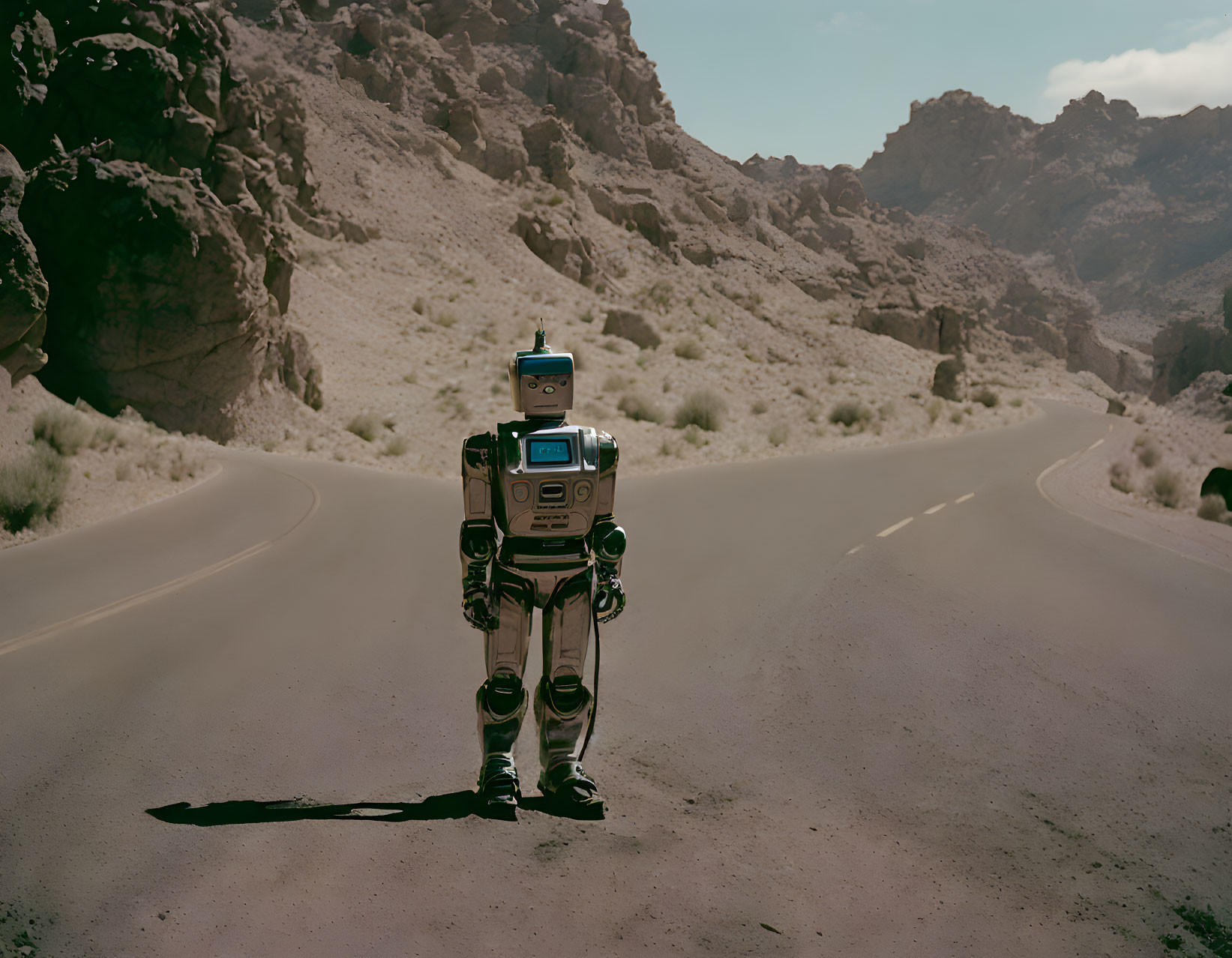 Robot on deserted road with rocky hills and clear sky