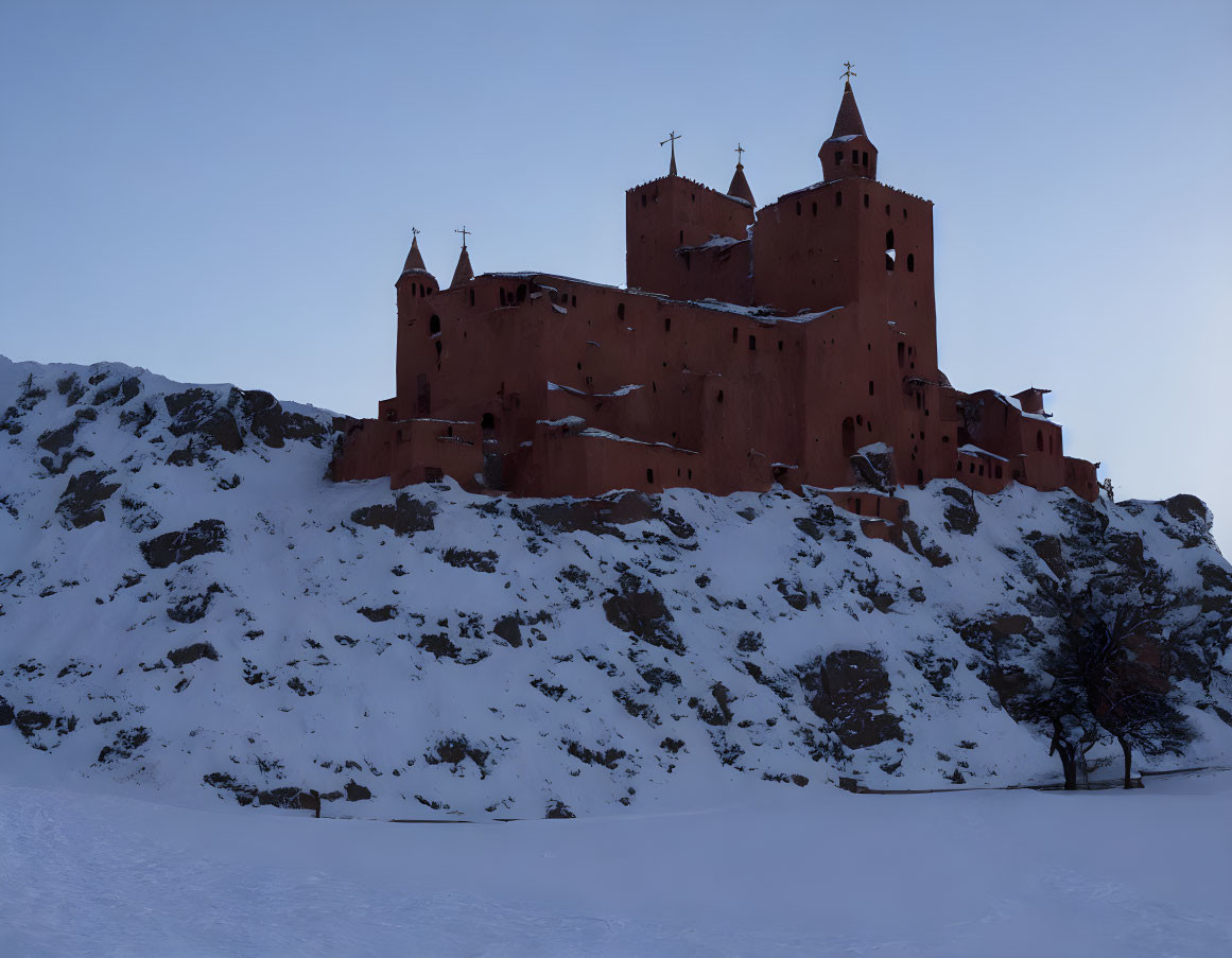 Red castle on snowy hill under dusky sky with lone tree