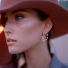 Profile view of fair-skinned woman in burgundy hat with sunflower earring, soft focus and