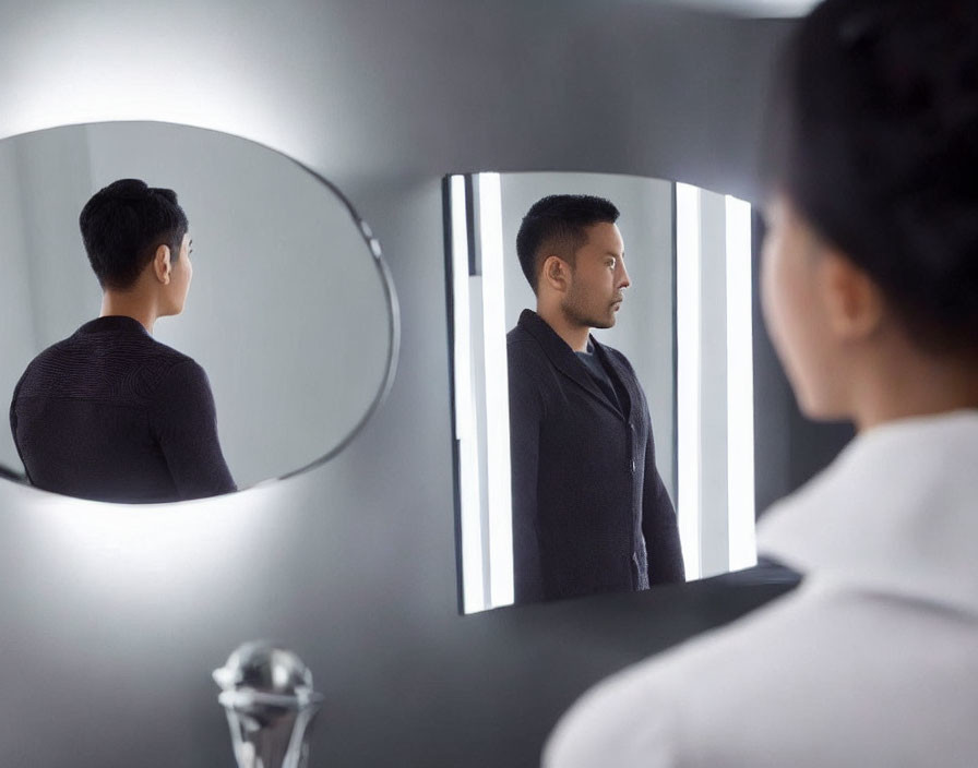 Man's side and back profile reflected in round mirrors.