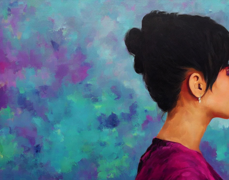 Elegant woman with bun on blurred multicolored backdrop