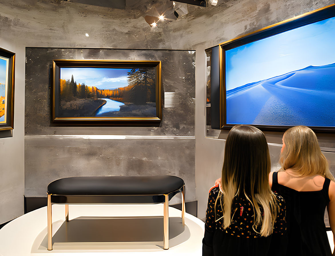 Gallery visitors admire river and desert landscape paintings with bench.