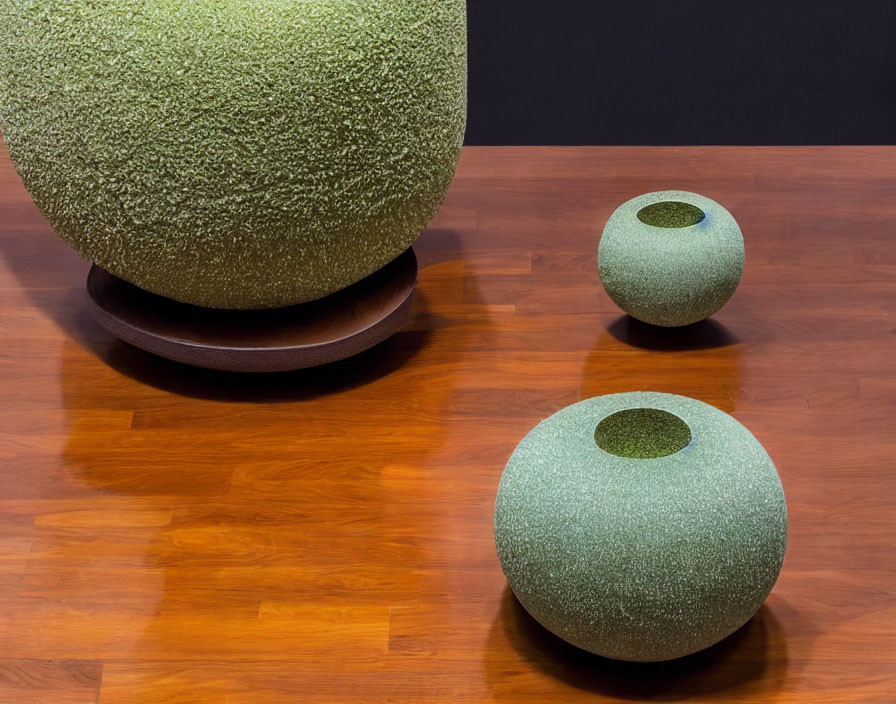 Three Textured Spherical Vases on Wooden Floor