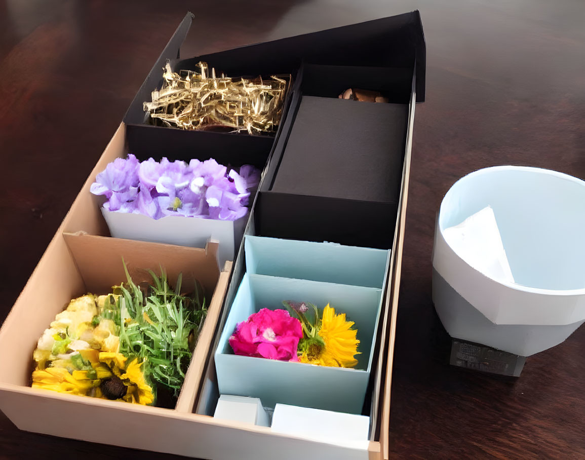 Drawer organizer with flowers, bowl, and decor on wooden surface