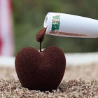 Pouring Liquid from Beaker into Cup with Coffee Beans